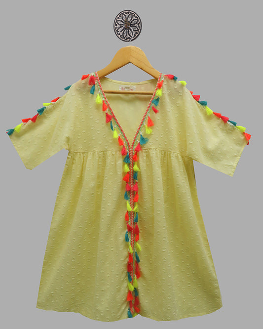 LIGHT YELLOW  COTTON DOBBY DRESS WITH GATHERS, HAS A V NECK AND COLOURFUL TASSELS