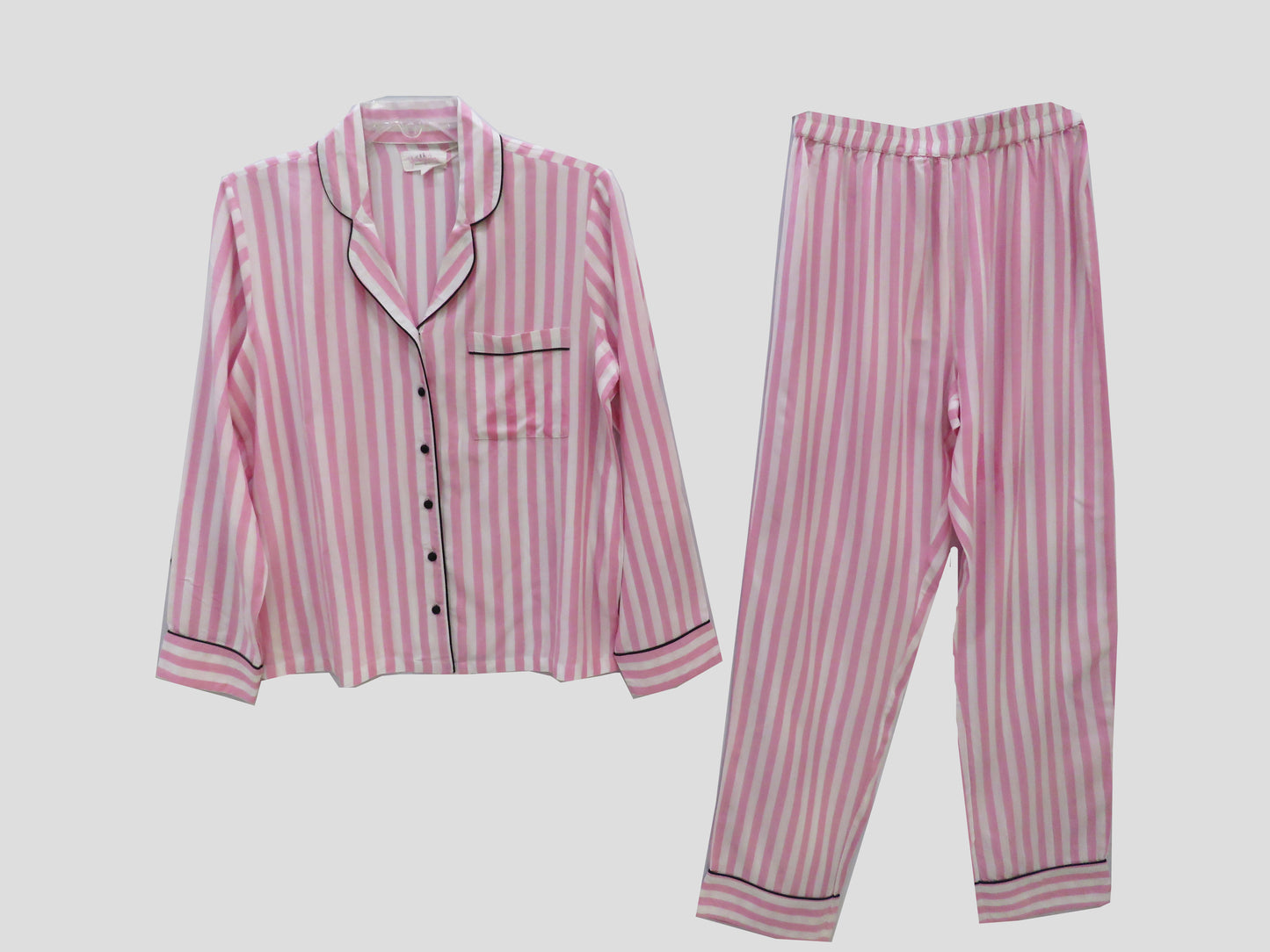 The Stunning 7 Peice Pink Nightsuit Set With Black Piping. Includes A Shirt, A Pair Pants,Shorts,Spaghetti Tops,Sleeping Mask, Scrunchie And A Pouch